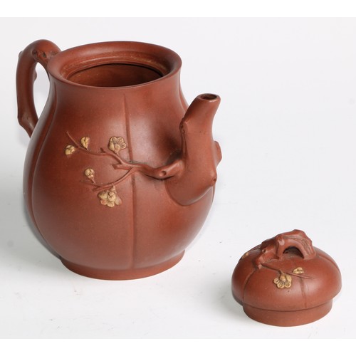 414 - A Chinese Yixing teapot, moulded with blossoming prunus, 15cm high, seal mark; others (4)