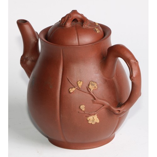 414 - A Chinese Yixing teapot, moulded with blossoming prunus, 15cm high, seal mark; others (4)