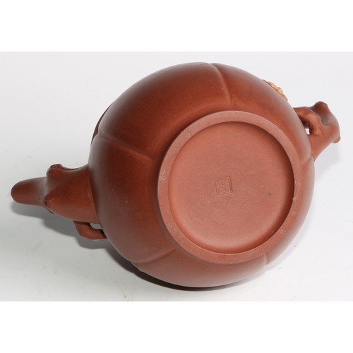 414 - A Chinese Yixing teapot, moulded with blossoming prunus, 15cm high, seal mark; others (4)