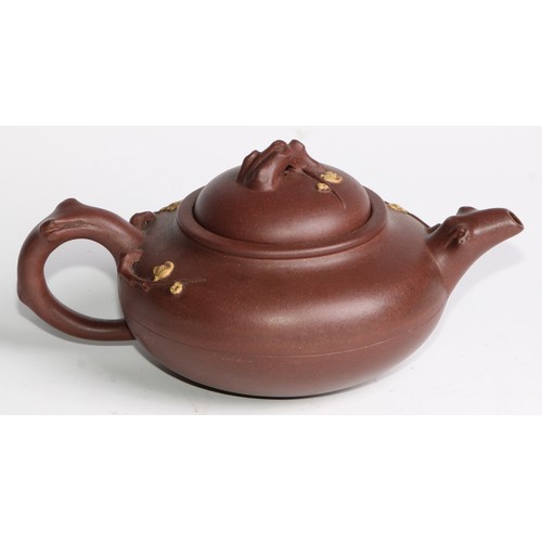 414 - A Chinese Yixing teapot, moulded with blossoming prunus, 15cm high, seal mark; others (4)