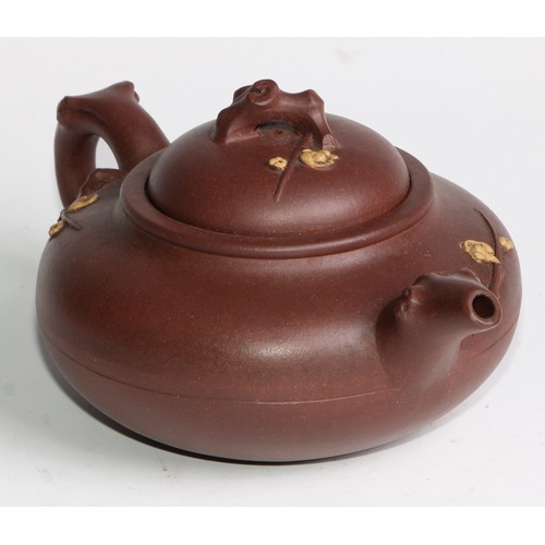 414 - A Chinese Yixing teapot, moulded with blossoming prunus, 15cm high, seal mark; others (4)