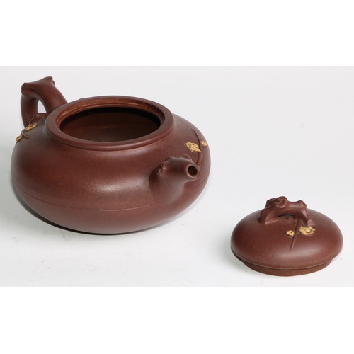 414 - A Chinese Yixing teapot, moulded with blossoming prunus, 15cm high, seal mark; others (4)