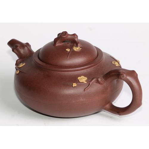 414 - A Chinese Yixing teapot, moulded with blossoming prunus, 15cm high, seal mark; others (4)