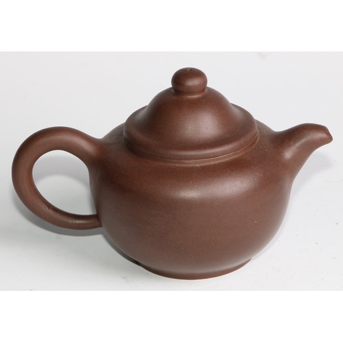 414 - A Chinese Yixing teapot, moulded with blossoming prunus, 15cm high, seal mark; others (4)