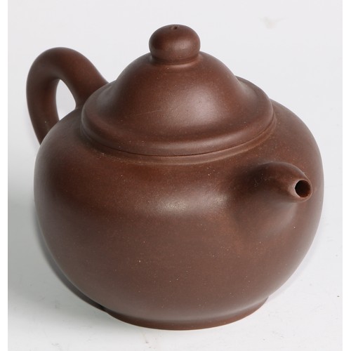 414 - A Chinese Yixing teapot, moulded with blossoming prunus, 15cm high, seal mark; others (4)