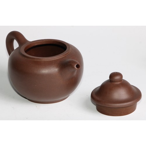 414 - A Chinese Yixing teapot, moulded with blossoming prunus, 15cm high, seal mark; others (4)