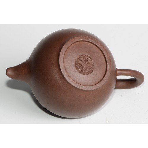 414 - A Chinese Yixing teapot, moulded with blossoming prunus, 15cm high, seal mark; others (4)