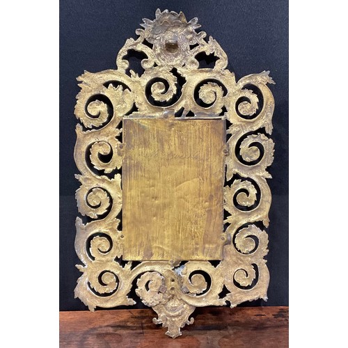 2011 - A 19th century gilt metal looking glass, cast in the Baroque taste with masks and scrolling foliage,... 