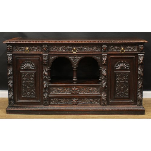 1608 - A 19th century historicist oak low dog-kennel dresser or side cabinet, rectangular top with lunette ... 