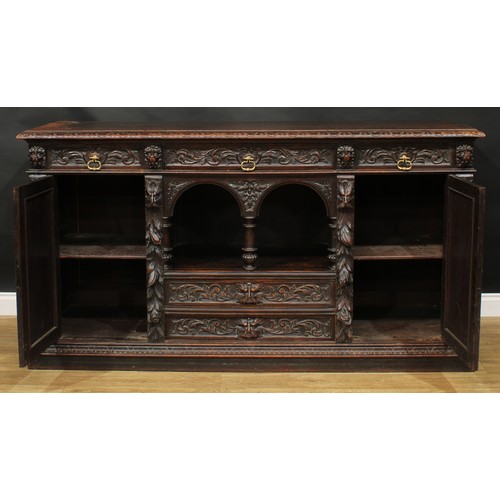 1608 - A 19th century historicist oak low dog-kennel dresser or side cabinet, rectangular top with lunette ... 