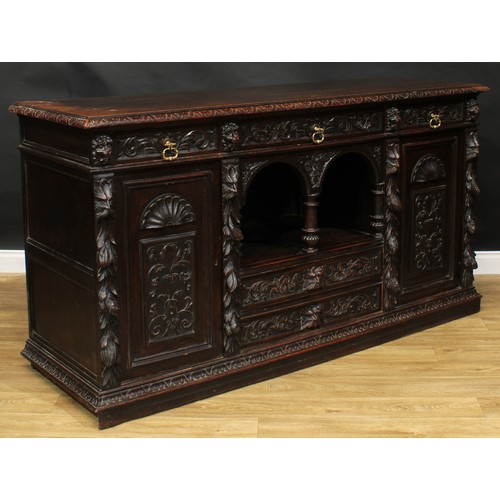 1608 - A 19th century historicist oak low dog-kennel dresser or side cabinet, rectangular top with lunette ... 