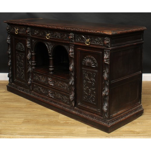 1608 - A 19th century historicist oak low dog-kennel dresser or side cabinet, rectangular top with lunette ... 