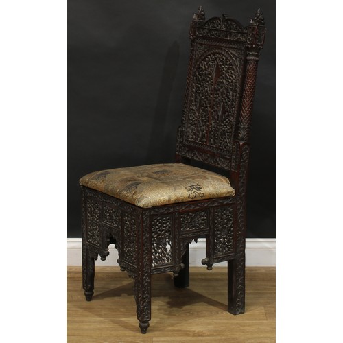 2396 - An Indo-Dutch design hardwood chair, pierced and carved throughout in the Batavian manner with meand... 