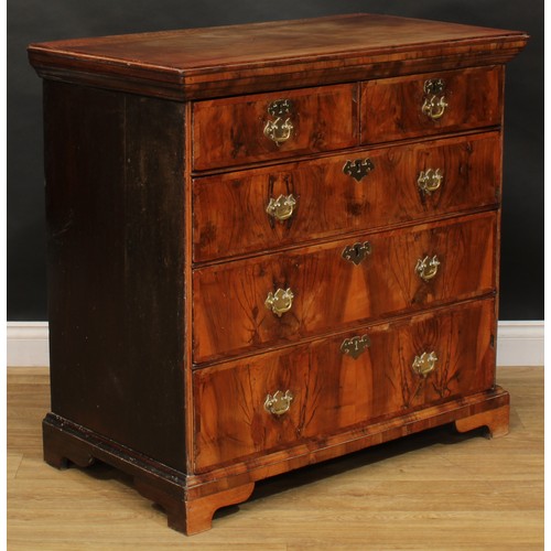 2679 - An early George II walnut chest, of two short and three long graduated drawers, swing handles, batwi... 