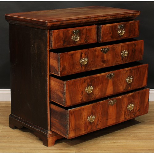 2679 - An early George II walnut chest, of two short and three long graduated drawers, swing handles, batwi... 