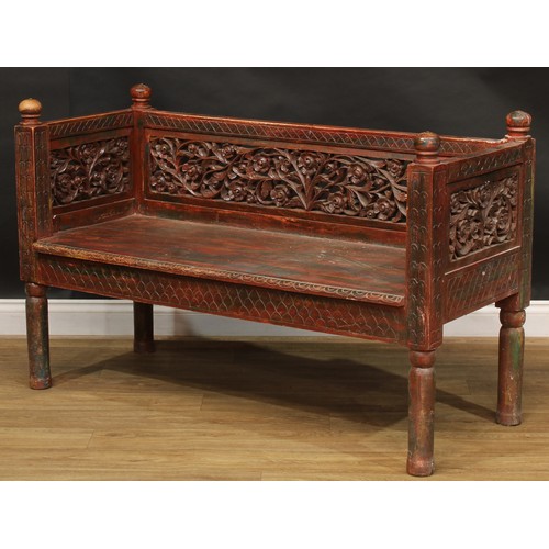 1970 - A mid-20th century Javanese stained and parcel-painted plantation bench, the back and sides pierced ... 