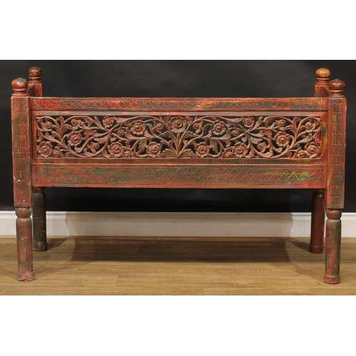 1970 - A mid-20th century Javanese stained and parcel-painted plantation bench, the back and sides pierced ... 