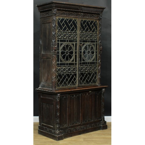 2151 - A historicist Revival oak library bookcase, outswept cornice with gadrooned capital above a pair of ... 