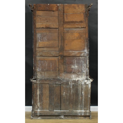 2151 - A historicist Revival oak library bookcase, outswept cornice with gadrooned capital above a pair of ... 