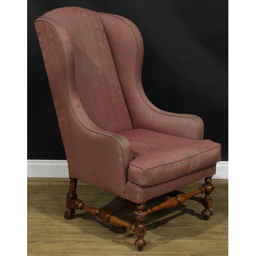 2305 - A William & Mary Revival wing chair, stuffed-over upholstery, squab cushion, turned and blocked supp... 