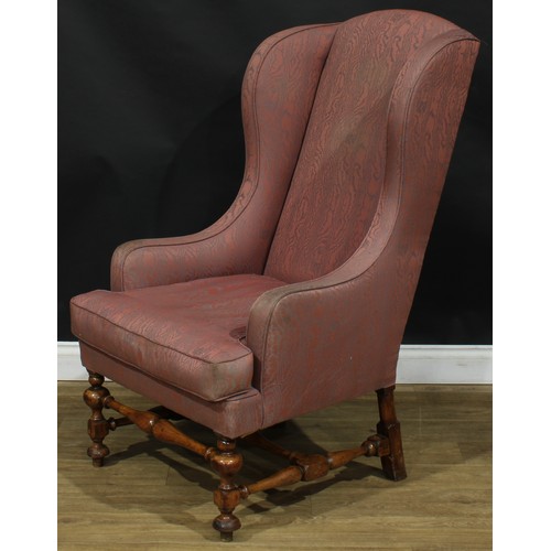 2305 - A William & Mary Revival wing chair, stuffed-over upholstery, squab cushion, turned and blocked supp... 