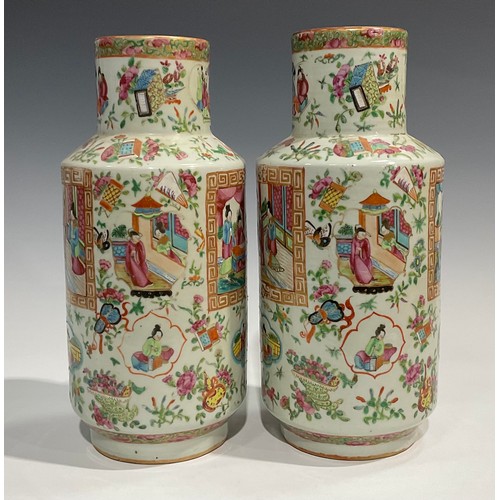 452 - A pair of Cantonese Famille Rose cylindrical vases, decorated with alternating shaped panels of Orie... 