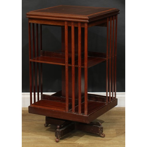 1880 - An Edwardian mahogany revolving bookcase, satinwood crossbanded square top above an arrangement of o... 