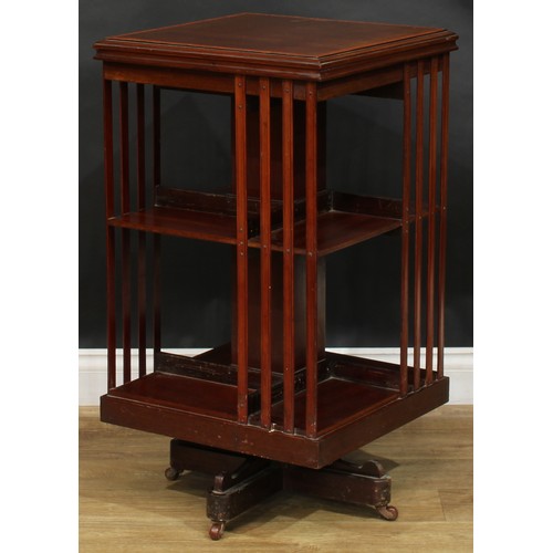 1880 - An Edwardian mahogany revolving bookcase, satinwood crossbanded square top above an arrangement of o... 