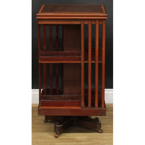 1880 - An Edwardian mahogany revolving bookcase, satinwood crossbanded square top above an arrangement of o... 