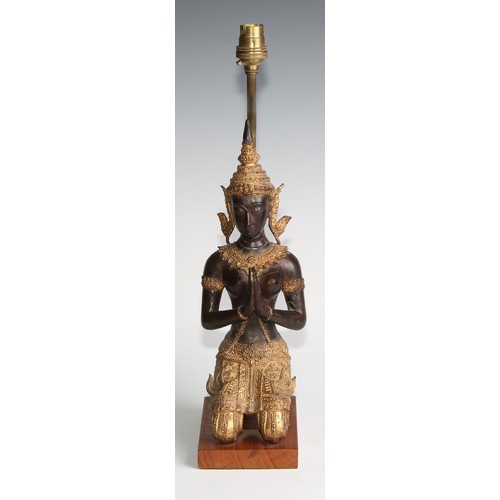 2021 - A mid-20th century Thai figural table lamp, with a parcel gilt kneeling Tara figure, hardwood base, ... 