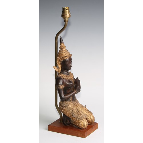 2021 - A mid-20th century Thai figural table lamp, with a parcel gilt kneeling Tara figure, hardwood base, ... 