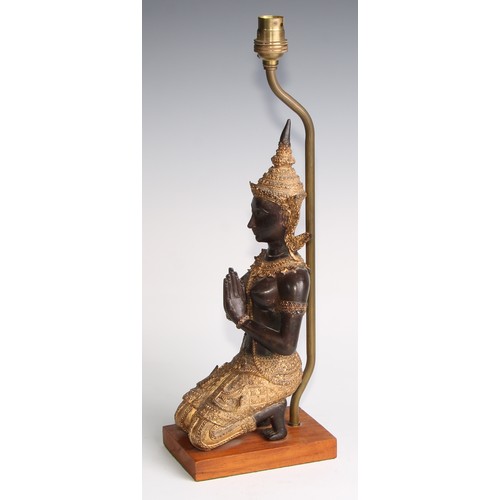 2021 - A mid-20th century Thai figural table lamp, with a parcel gilt kneeling Tara figure, hardwood base, ... 