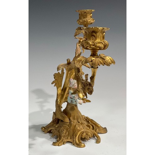 2094 - A pair of Rococo Revival gilt metal two-light candelabra, each cast with flowers and scrolling acant... 