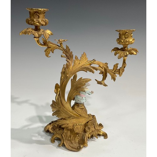 2094 - A pair of Rococo Revival gilt metal two-light candelabra, each cast with flowers and scrolling acant... 