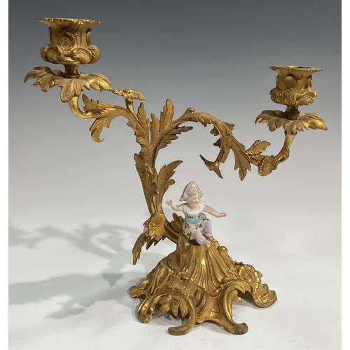 2094 - A pair of Rococo Revival gilt metal two-light candelabra, each cast with flowers and scrolling acant... 