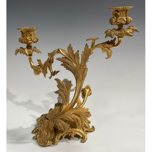 2094 - A pair of Rococo Revival gilt metal two-light candelabra, each cast with flowers and scrolling acant... 