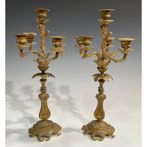 1819 - A pair of 19th century gilt metal five-light candelabra, cast throughout with acanthus in the Rococo... 