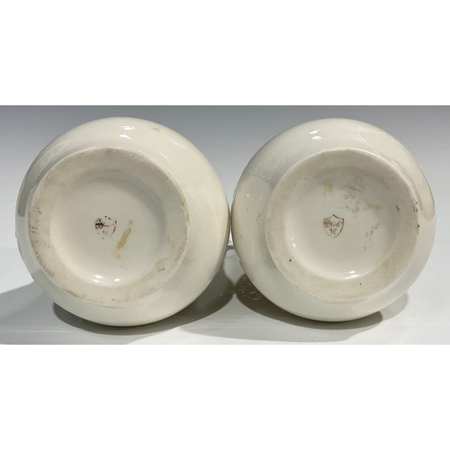 183 - A pair of Graingers Worcester reticulated spreading ovoid vases, in the white, with Persian inspired... 