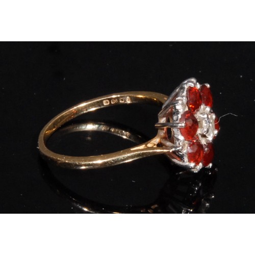 1360 - A diamond and garnet floral cluster ring, central brilliant cut diamond approx 0.25ct, surrounded by... 