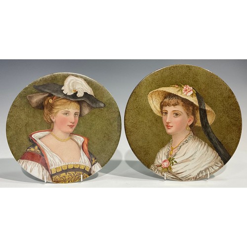 56 - A near pair of Aesthetic Movement circular plaques, painted by Magda Osborne Hilliard, with ladies o... 