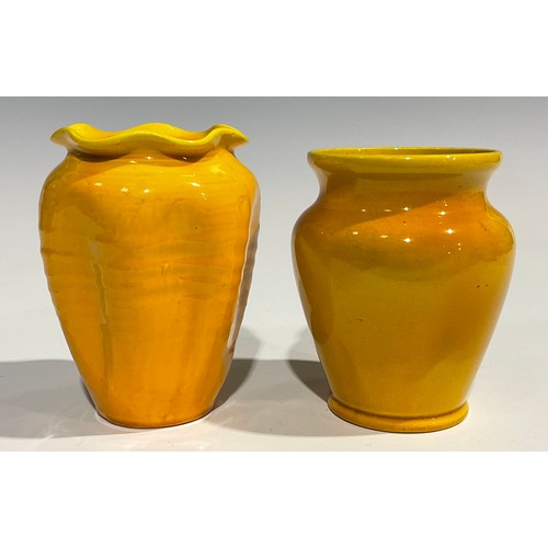 31 - A Burmantofts Faience dimpled ovoid vase, flared frilled rim, glazed throughout in yellow, 12.5cm hi... 