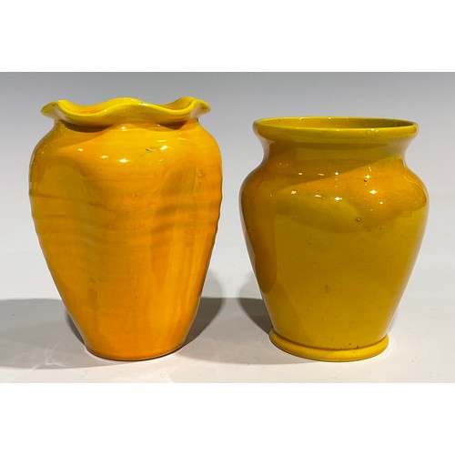 31 - A Burmantofts Faience dimpled ovoid vase, flared frilled rim, glazed throughout in yellow, 12.5cm hi... 