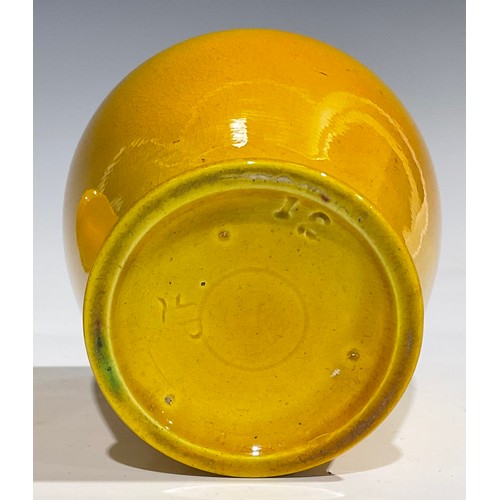 31 - A Burmantofts Faience dimpled ovoid vase, flared frilled rim, glazed throughout in yellow, 12.5cm hi... 