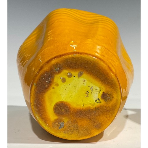 31 - A Burmantofts Faience dimpled ovoid vase, flared frilled rim, glazed throughout in yellow, 12.5cm hi... 