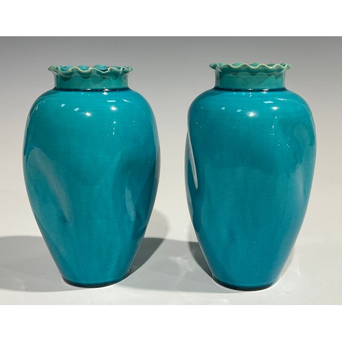 58 - A pair of Burmantofts Faience dimpled ovoid vases, flared frilled rims, glazed throughout in turquoi... 