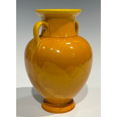 43 - A Burmantofts Faience two handled amphora shaped vase, glazed throughout in yellow, 23cm high, shape... 