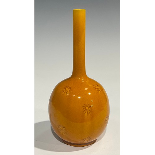 28 - A Burmantofts Faience bottle vase, the globular body applied with sgraffito sunbursts, long cylindri... 
