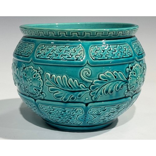 34 - A Burmantofts Faience jardiniere, relief moulded with stylised flowers and foliage with basket weave... 
