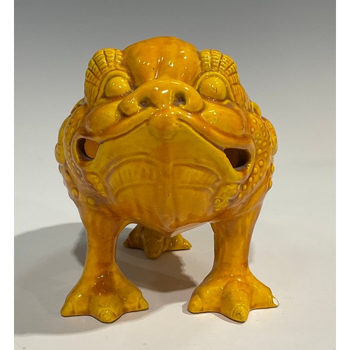 42 - A Burmantofts Faience spoon warmer, as a grotesque three-legged toad, Jin Chan Toad, glazed througho... 