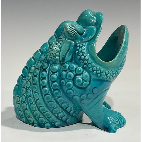 39 - A Burmantofts Faience spoon warmer, as a grotesque seated toad, glazed throughout turquoise, 12.5cm ... 
